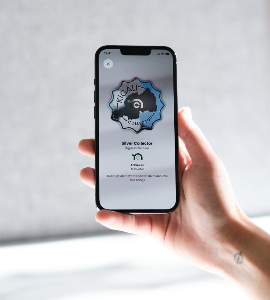 a smartphone held by a human hand that shows a screendesign created for the nature collectibles nft marketplace dApp by blokk studio
