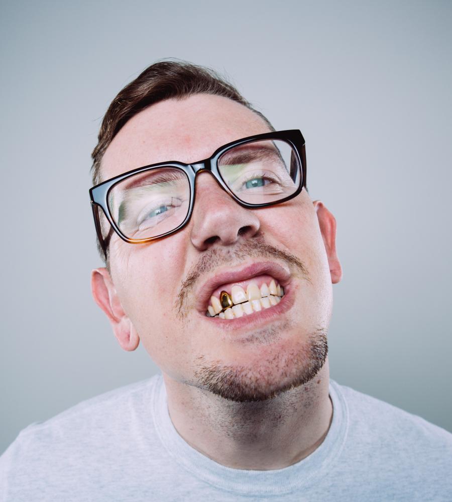 Portrait of a man around 30 years old that has a gold teeth.